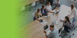 Group of business professionals having a discussion while sitting at a rectangle table