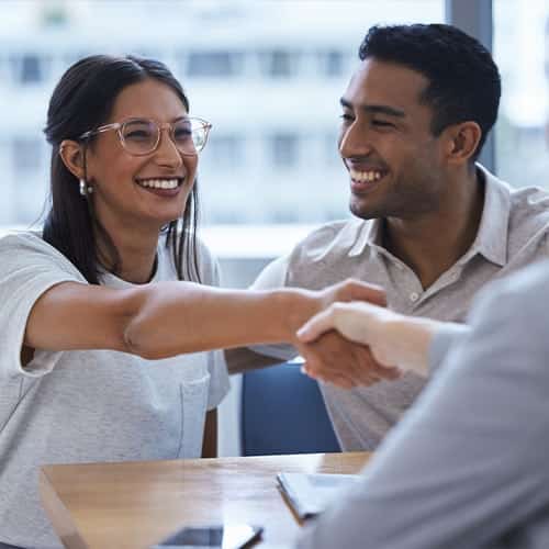 Happy consumer handshake with a manager