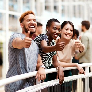 Group of young people showing thumbs up