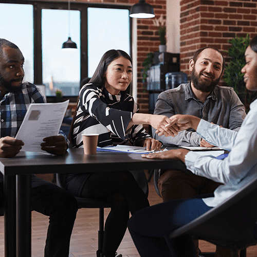 Hiring team shaking hands with a candidate