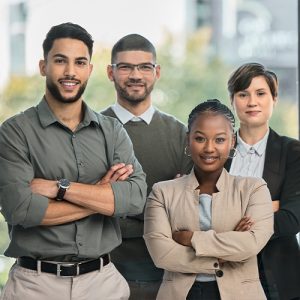Group of confident business professionals folding hands looking at camera